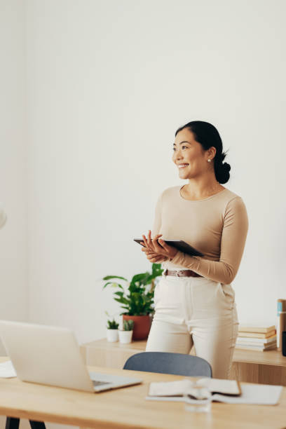 istock Beautiful Business Woman Using Digital Tablet at Home 1350926651