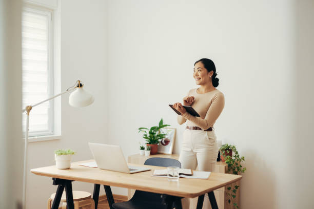 istock Beautiful Business Woman Using Digital Tablet at Home 1350926660