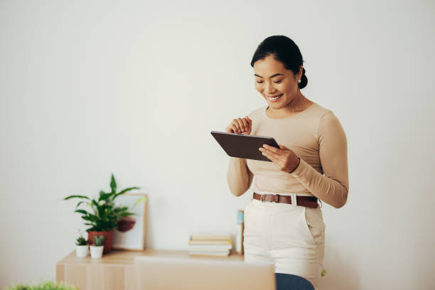 istock Smiling Business Woman Using Digital Tablet at Home 1350926676