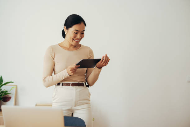 istock Happy Business Woman Using Digital Tablet at Home 1350926678