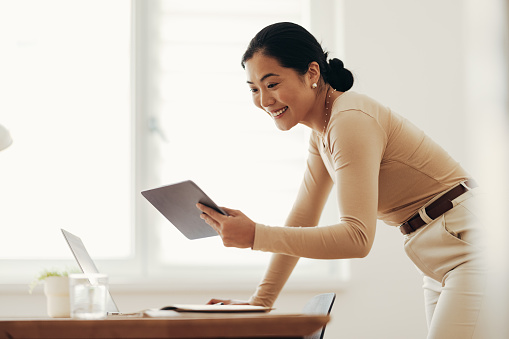 Cheerful Business Woman Using Digital Tablet at Home