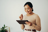 istock Happy Business Woman Using Digital Tablet at Home 1350926687