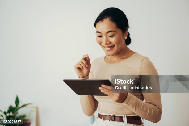 Happy Business Woman Using Digital Tablet At Home Stock Photo - Download Image Now - Digital Tablet, Women, One Woman Only