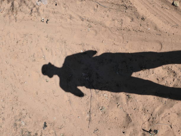 Picture of a silhouette reflecting in the sand