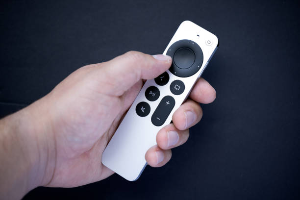 istock A person holding a new digital media player and microconsole control remote control on a dark background 1350932278