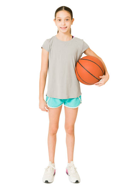 istock Cheerful girl taking basketball lessons 1350932810