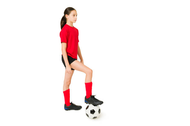 istock Fit girl playing soccer against a white background 1350933277
