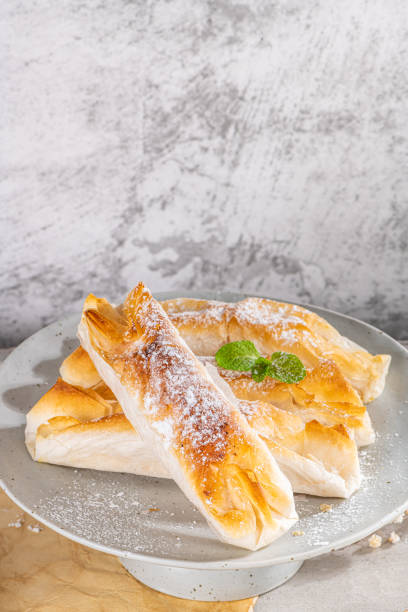 istock Typical portuguese sweets Pasteis de Vouzela served on countertop. Filo pastry with egg cream filling 1350938640