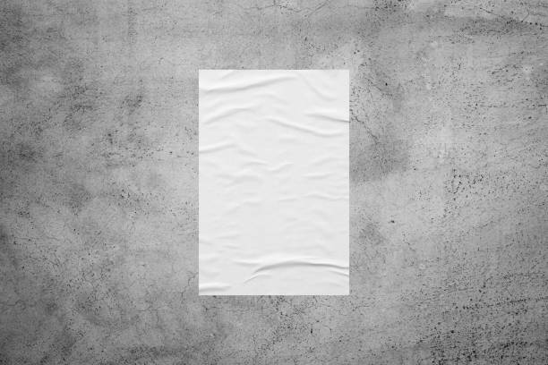 istock Blank white wheatpaste glued paper poster mockup on concrete wall background 1350941157