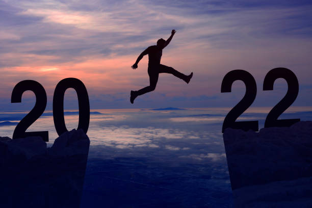 istock New Year Concept From 2021 to 2022, Silhouette Man jumping 1350942245