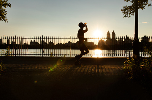 Jogger during sunset in Central Park, New York City.