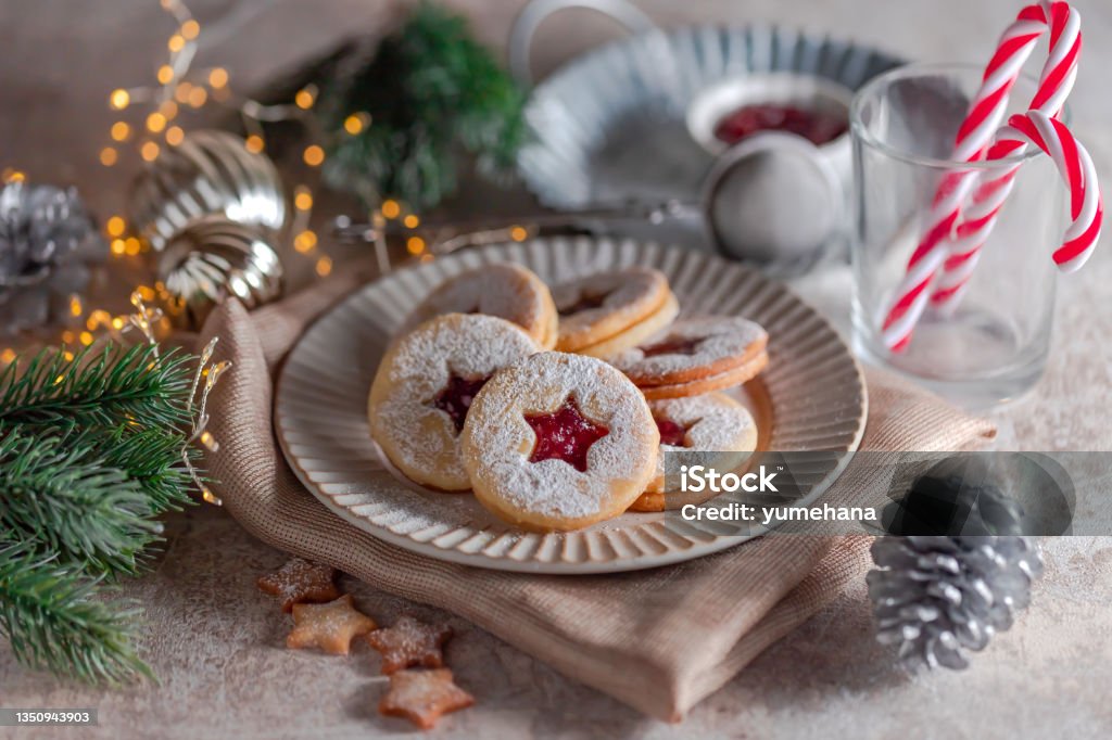 Linzer Christmas cookies filled with raspberry jam on concrete background Christmas Stock Photo