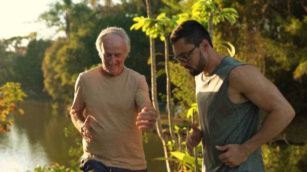 istock Fitness instructor training a senior man 1350953759