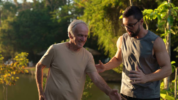 istock Fitness instructor training a senior man 1350953762