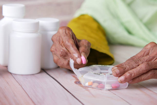 istock senior women hands taking medicine from a pill box 1350955005
