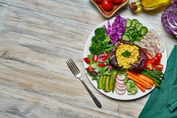 istock Diet concepts. Top view of spring salad on rustic wooden table with copy space 1350955994