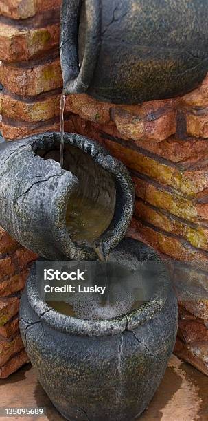 Trickle Down Effect Stock Photo - Download Image Now - Jug, Pouring, Stone - Object