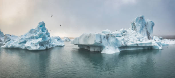 Jökulsarlon Iceland Iceberg Glacier Lagoon Panorama Jökulsárlón Icebergs Iceland Jökulsarlon Glacier Lagoon Panorama. View to the drifting Icebergs on the natural glacier lake lagoon of Jökulsarlon in moody and foggy sunset twilight light. Jokulsarlon, Drone Flight Point of View. Vatnajökull National Park, Route 1, Southeast Iceland, Iceland, Nordic Countries, Northern Europe national road stock pictures, royalty-free photos & images