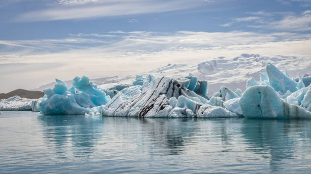 Iceland Jokulsarlon Glacier Lagoon Icebergs in Summer Jökulsárlón Lagoon Jokulsarlon Glacier Lagoon in Summer under blue sunny skyscape. Icebergs floating on the glacier lake from the Vatnajokull Glacier along the glacier lagoon into the North Atlantic Ocean. Jokulsarlon, Vatnajökull National Park, Route 1, Southeast Iceland, Iceland, Nordic Countries, Northern Europe national road stock pictures, royalty-free photos & images