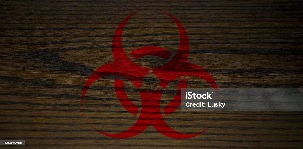 Bio Hazard on a natural wood background Bio Hazard symbol on a natural wood textured background symbolising the dangers we face with ecology if we keep poisoning the earth Backgrounds Stock Photo