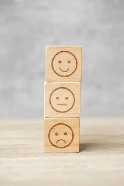 Photo of emotion face symbol on wooden blocks. mood, Service rating, ranking, customer review, satisfaction, evaluation and feedback concept