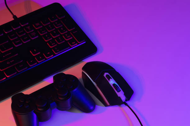 istock Accessory gaming keyboard joystick mouse headphone with blank space. Gadget for gamer playing video game online in the neon light darkroom. 1350960520