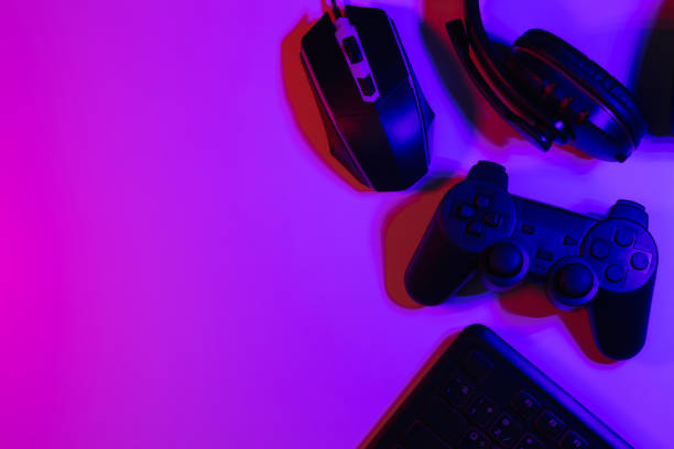 istock Accessory gaming keyboard joystick mouse headphone with blank space. Gadget for gamer playing video game online in the neon light darkroom. 1350960544