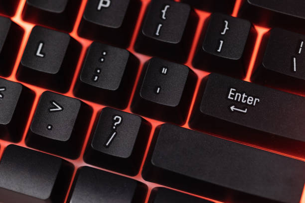istock Colorful Accessory gaming keyboard with blank space background. Gadget for gamer playing video game online in the neon light darkroom. 1350960561