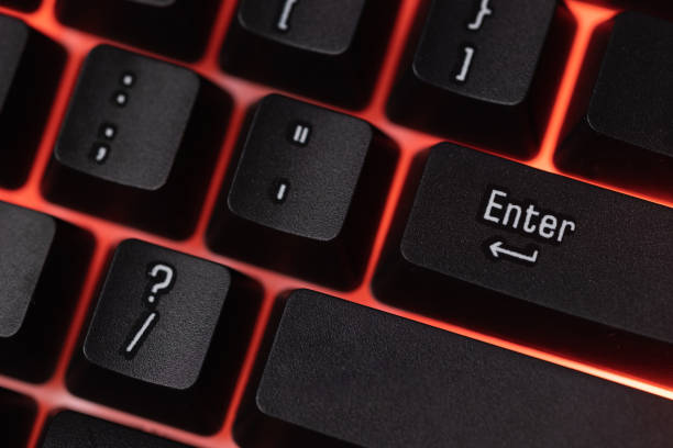 istock Colorful Accessory gaming keyboard with blank space background. Gadget for gamer playing video game online in the neon light darkroom. 1350960563