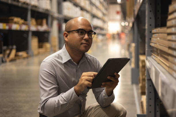istock Young manager worker checklist manage parcel box product in warehouse. Asian supervisor man using tablet working at store industry. Logistic import export concept. 1350960641