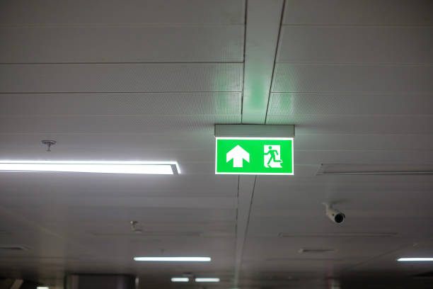 istock Fire Emergency exit sign on the wall inside building at subway train station. Safety concept 1350960761