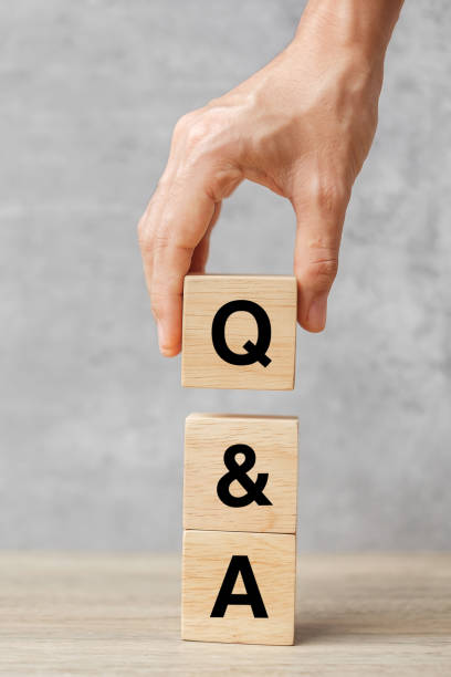istock Hand holding Q and A word with wooden block. FAQ( frequency asked questions), Answer, Question  Ask, Information, Communication and Brainstorming Concepts 1350962939