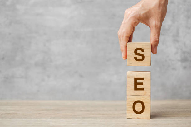 istock SEO (Search Engine Optimization) text wooden cube blocks on table background. Idea, Strategy, advertising, marketing, Keyword and Content concept 1350962947