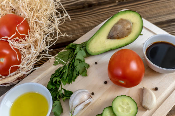 istock Tomatoes, cucumbers and avocado on the table, olive oil and balsamic vinegar, garlic, vegetables, vegetarianism, healthy eating 1350966511