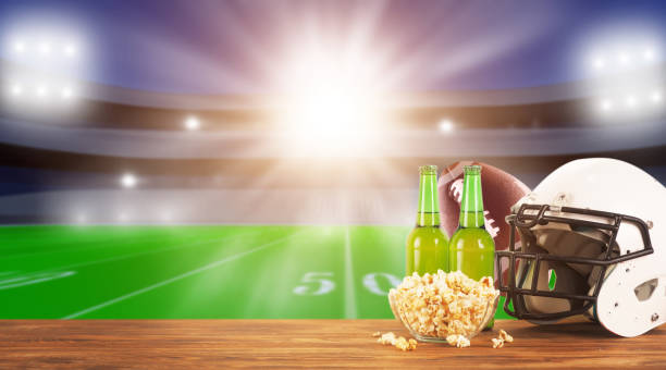 food and drinks on a wooden table . tv broadcast of american football background. sport bar concept - american football football food snack imagens e fotografias de stock