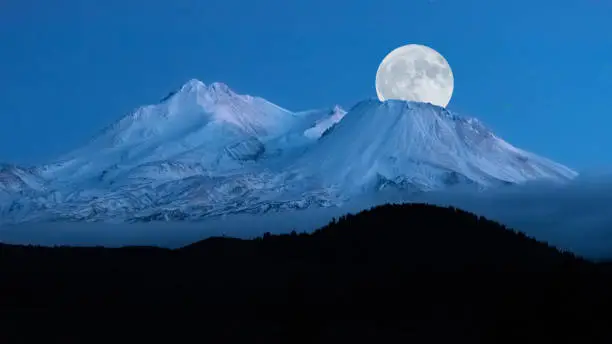 Photo of Full moon rising over Mt. Shasta