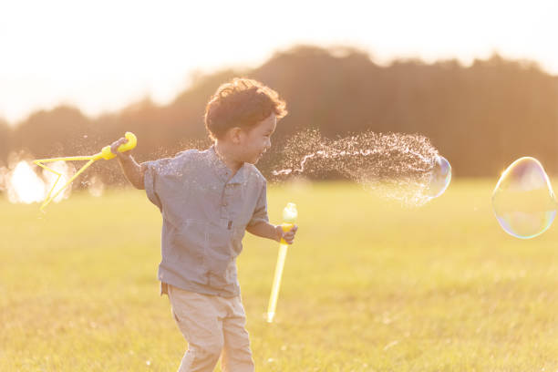 A little boy playing with soap bubbles in the park.Asian Ethnicity,canon R5 shooting.