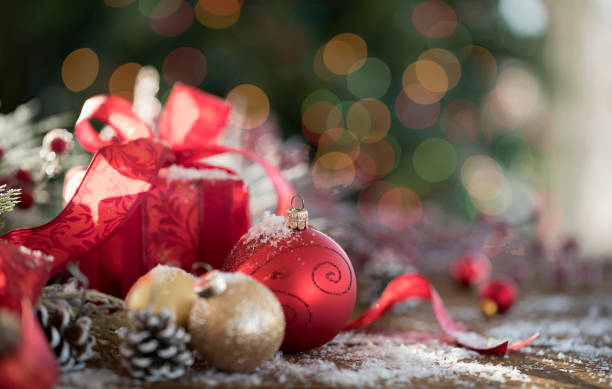 istock Christmas Gift and Baubles on Christmas Lights Background 1350974343