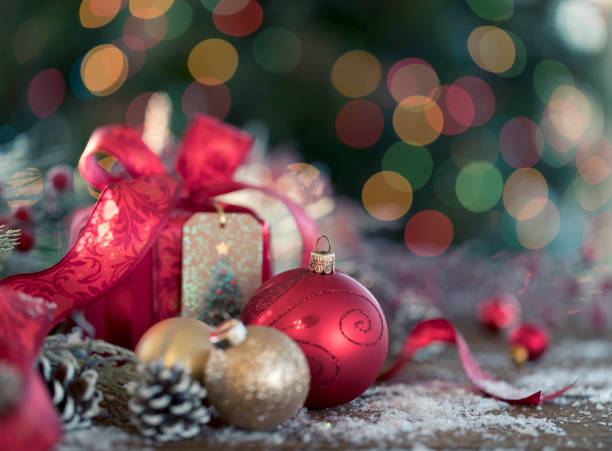 istock Christmas Gift and Baubles on Christmas Lights Background 1350974888