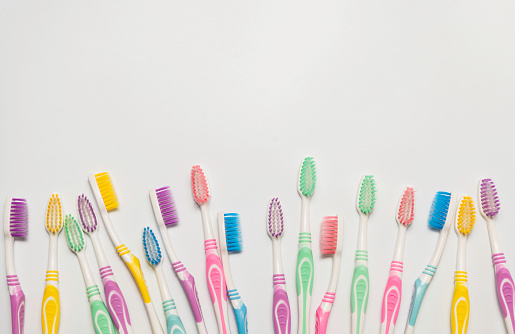 Top view of toothbrushes in colorful on pastel color background.