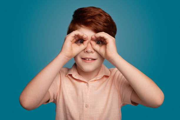 istock Ginger boy gesturing binocle sign on studio in trendy style. Fashion model. 1350982644