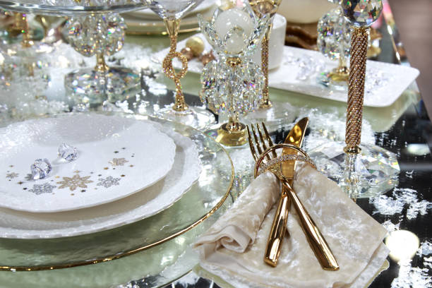 Festive xmas new year table setting with beautiful tableware and decor in shiny shining golden colors