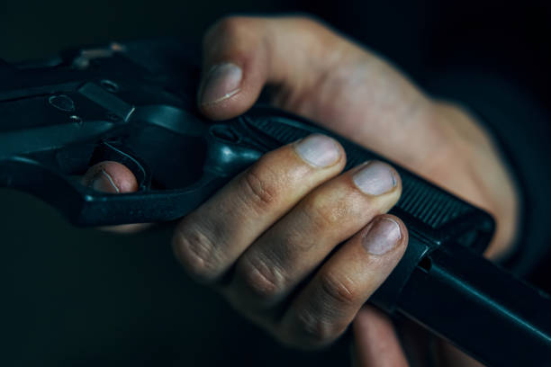 istock Close up of man reloading pistol. 1350990439