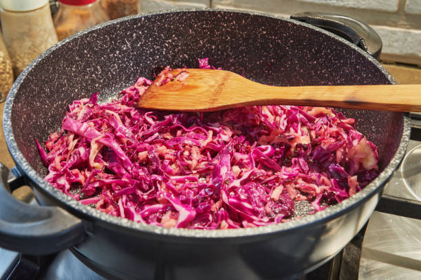 Red cabbage is fried in pan on gas stove Red cabbage is fried in pan on gas stove. red cabbage stock pictures, royalty-free photos & images