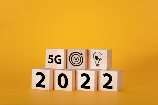 istock Wooden cubes on a yellow background and 2022. 1350990941