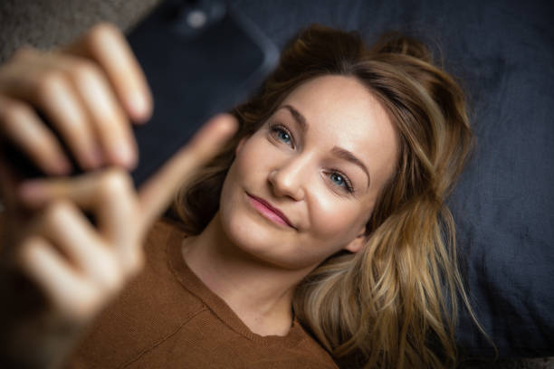 istock Pretty, young woman using her smart phone 1350998508