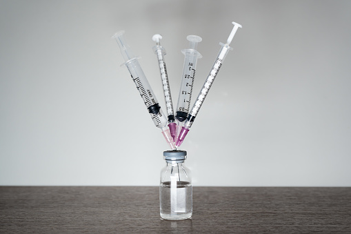 A vaccine vial with 4 syringes.