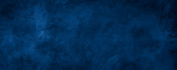 istock Dark blue rough grainy stone or concrete wall texture background 1351000205