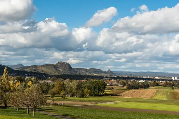 View of the Hegau landscape with the volcanic mountains Hohenhewen, Hohentwiel and Hohenkraehen (from left) and the town of Singen, Konstanz district, Baden-Wuerttemberg, Germany