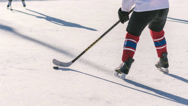 istock the man plays hockey on the rink 1351000763